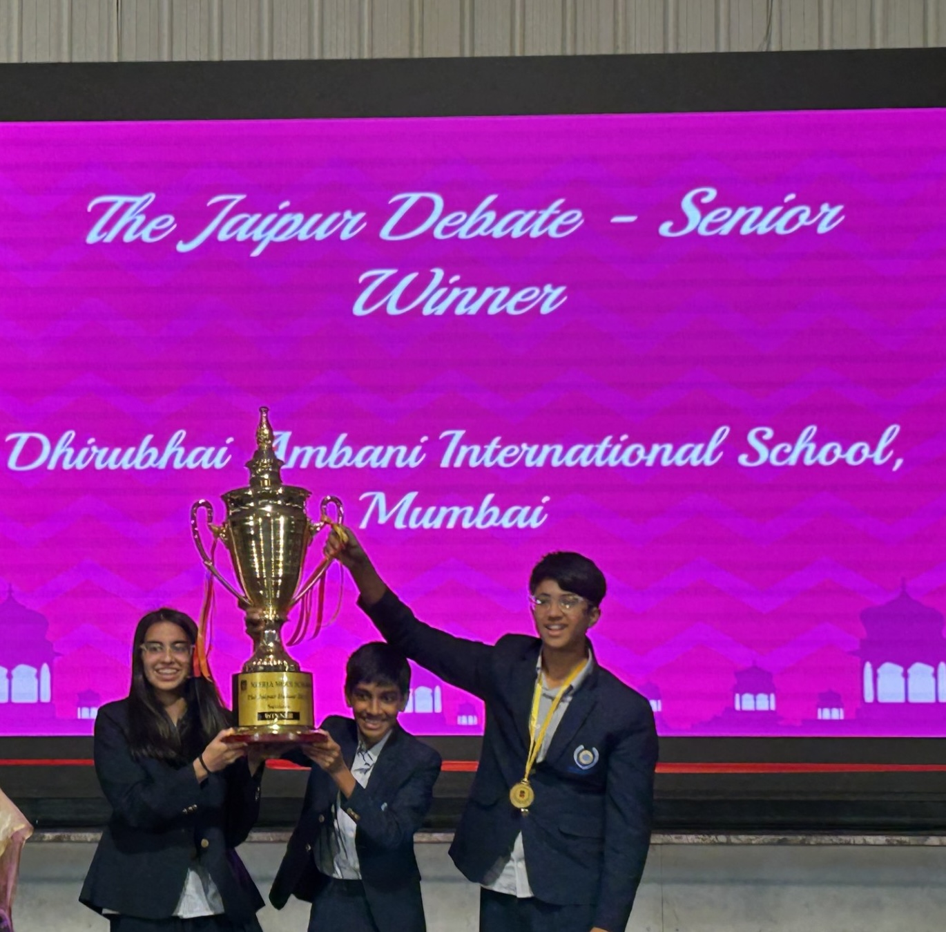 Dhirubhai Ambani International School team holding the Jaipur Debate winner trophy