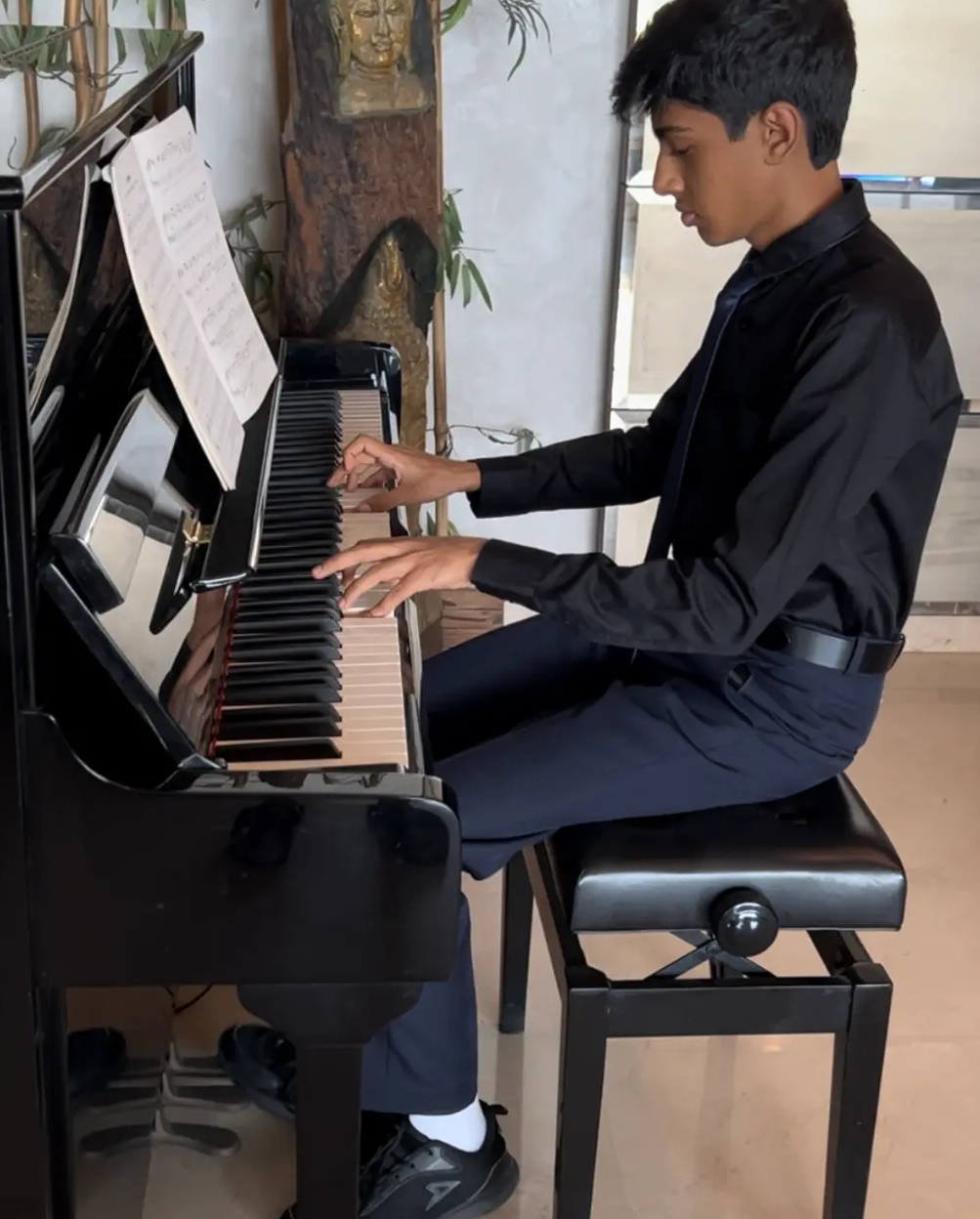 Apoorv playing the piano in formal attire